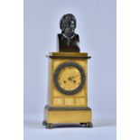 A Louis Philippe ormolu and bronze Mantel Clock Surmounted by a male bust on a stepped pediment