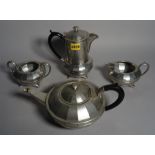 'Kendal & Dent'; an early 20th century pewter four piece tea set.