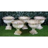 A set of five reconstituted stone circular jardinieres with semi-fluted bodies on turned socles,