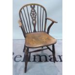 A 19th century ash and elm wheelback Windsor chair, on turned supports, 57cm wide x 88cm high.