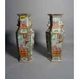 A pair of late 19th century Canton famille rose vases, 35cm high, (a.f.).