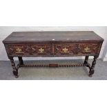 A Charles II oak dresser base with a pair of geometric moulded frieze drawers on baluster turned