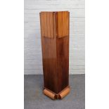 An Art Deco walnut plinth of stepped square form, on split turned base, 40cm wide x 135cm high.