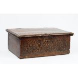 A 17th century oak bible box with carved front panel, 59cm wide x 23cm high.