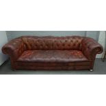 An early 20th century button back brown leather upholstered brass studded Chesterfield sofa,