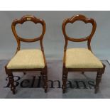 A set of six Victorian mahogany balloon back dining chairs, on turned supports,