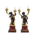 A pair of Napoleon III ormolu, patinated bronze and rouge griotte marble twin light candelabra,