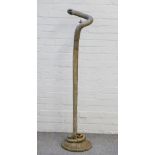 An early 20th century tall bronze standard lamp formed as a coiled snake resting on a basket