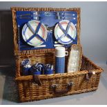 A quantity of mid-20th century Ordanance Survey maps and a wicker picnic hamper,