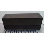 Bang & Olufsen, a modern black and smoke glass TV stand, 125cm wide x 58cm high.