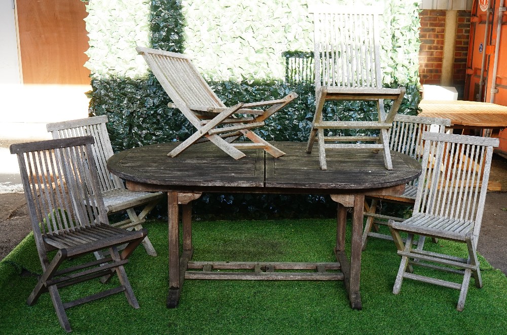 A teak oval extending garden table, 100cm wide x 180cm x long x 240cm long extended,