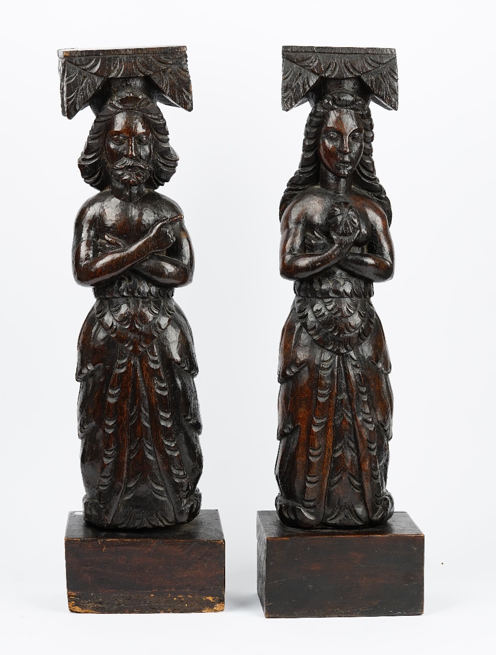 A pair of 19th century carved oak finials, depicting a man and a woman in standing pose,