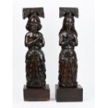A pair of 19th century carved oak finials, depicting a man and a woman in standing pose,