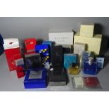 A quantity of modern mostly boxed perfume bottles including Cartier, Dunhill, Lalique,
