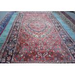A Mahal carpet, Persian, the madder field with a bold rosette medallion,