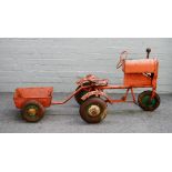 A mid-20th century Triang tin plate pedal tractor and cart,