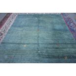 A Gabeh carpet, Persian, the plain petrol green field with single mirror animals and figures,