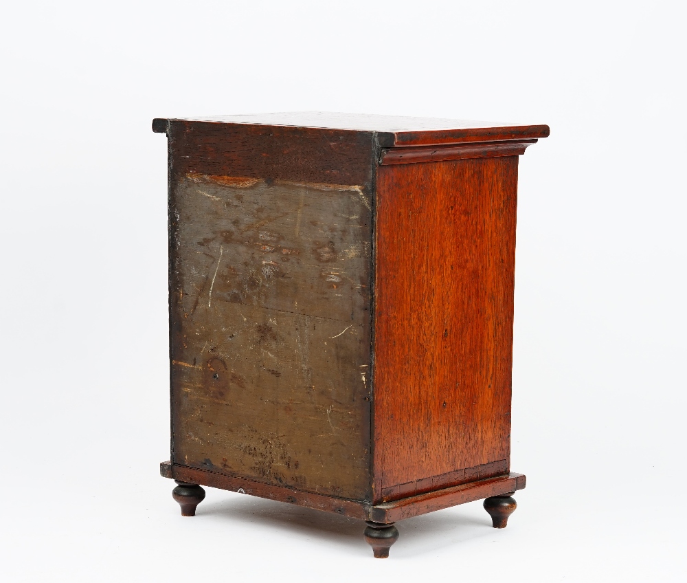 A miniature mahogany chest with a cushion drawer over four long graduated drawers on bun feet, - Image 2 of 5