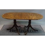 A Regency style mahogany D-end dining table with an extra leaf,