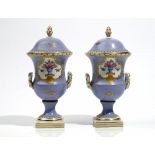 A pair of small French porcelain lilac-ground two-handled vases and covers, circa 1900,
