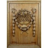 A 19th century pine and limewood relief carving depicting ribbon tied floral sprays in an open