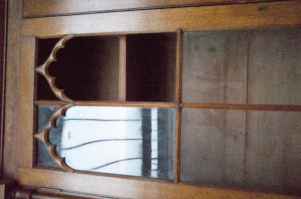 A Victorian oak Gothic revival bookcase cabinet with four arched astragal glazed doors divided by - Image 3 of 6