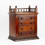 A 19th century walnut table top chest with a galleried top over four long graduated drawers,