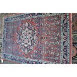 A Mahal rug, Persian, the madder field with a bold medallion,