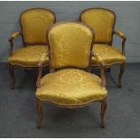 A set of three 18th century style French stained beech open armchairs with serpentine seat on