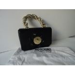 A Moschino Cheap and Chic black leather evening bag with a gold-tone hardware rope twist handle,