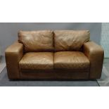A modern brown leather two seat sofa on block supports, 183cm wide x 95cm deep.