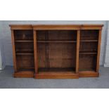 A Victorian mahogany floor standing breakfront open bookcase, on plinth base,