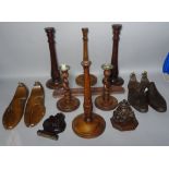 Six modern turned wooden candlesticks, two pairs of shoe lasts and three carvings.