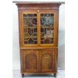 A 19th century mahogany floor standing corner display cabinet with astragal glazed doors on turned