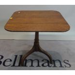 A late 18th century oak tripod table with rectangular top on three downswept supports,