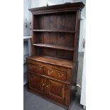 An elm dresser, 18th century, with two drawers and a cupboard below,