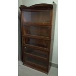 The Lebus bookcase, oak five section glazed bookcase with up and over doors on plinth base,