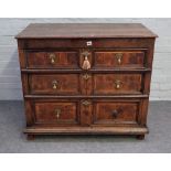 A late 17th century oak chest with three long graduated oyster veneered drawers,