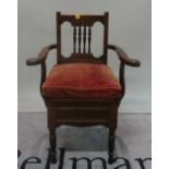 A Victorian mahogany framed open armchair commode on ring turned supports, 65cm wide x 97cm high.