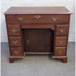 A mid-18th century mahogany kneehole writing desk with seven drawers above the knee hole cupboard