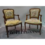 A pair of Louis XV style stained beech open armchairs, 55cm wide x 84cm high.