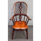 A Victorian Windsor chair with Yew hoop back and splat over elm seat on turned supports,