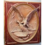 A large oval relief moulded plaque, signed 'CAIN', depicting a bird of prey attacking a duck,