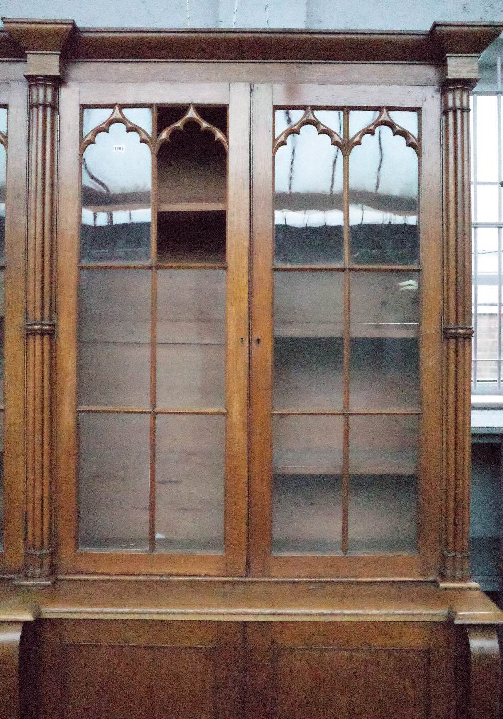 A Victorian oak Gothic revival bookcase cabinet with four arched astragal glazed doors divided by - Image 2 of 6