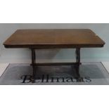 A modern stained beech extending rectangular dining table,