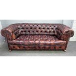 A 20th century button back brown leather upholstered Chesterfield, with brass studded decoration,