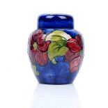 A Walter Moorcroft clematis pattern ginger jar and cover, tube lined against a blue ground,