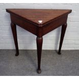 An 18th century oak corner/handkerchief foldover games table on club supports,