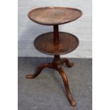 A provincial 18th century oak circular two tier dumbwaiter on tripod base,