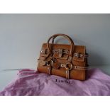 A Luella 'Giselle' tan leather handbag, with twin leather loop handles and strap decoration,